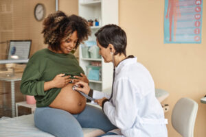 Black pregnant woman at antenatal clinic for preeclampsia and maternal health screening